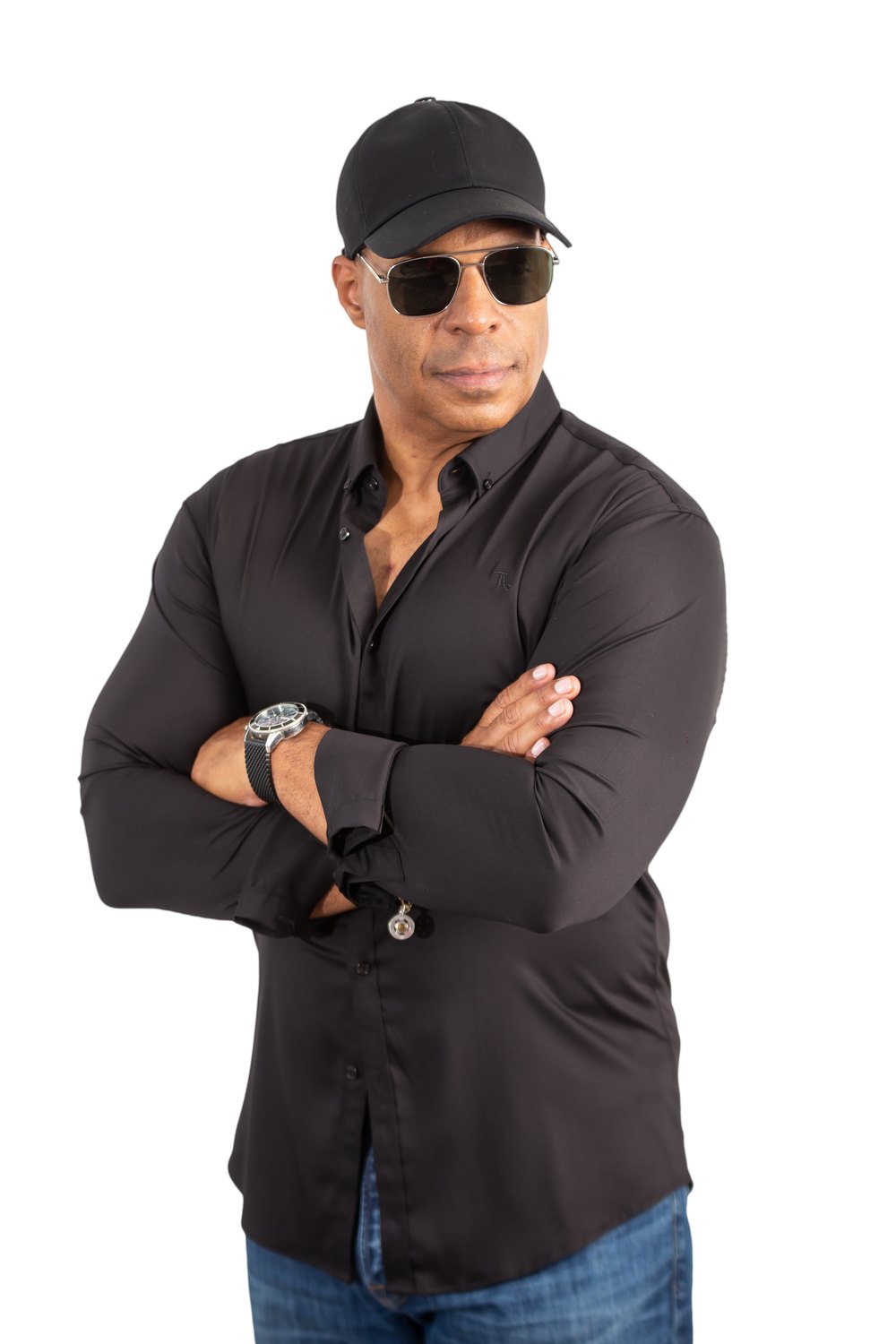Retrato de Oliver Velez con su gorra y gafas de sol, brazos cruzados